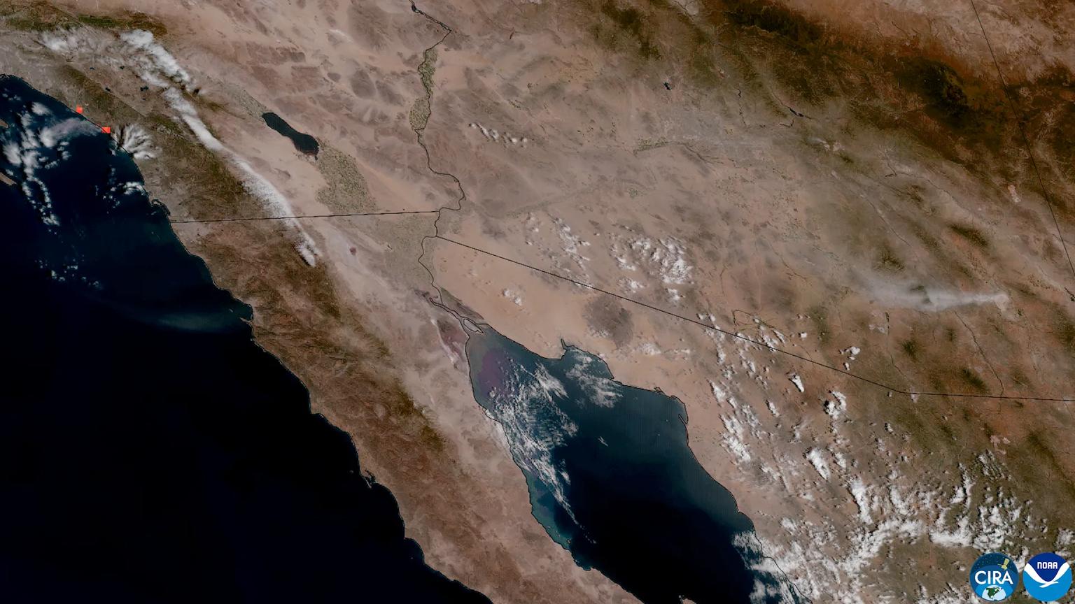 GOES satellite image of Southern California, the Salton Sea and the Gulf of California on October 16, 2026, with red fire-detection marks on the coast at upper left and a pale dust plume at right