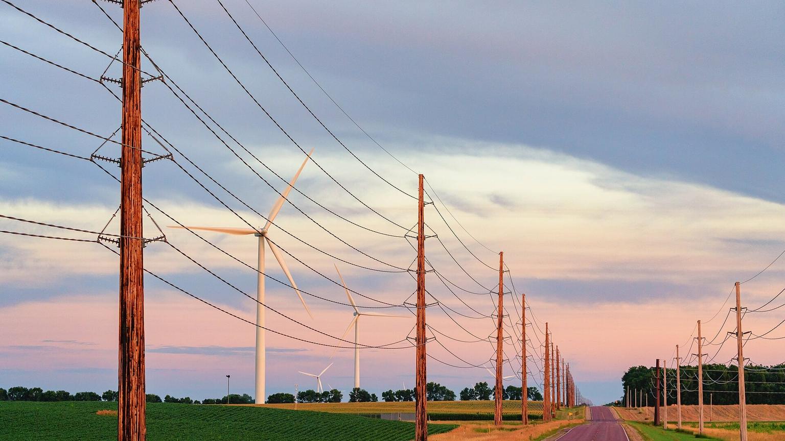 Electrical transmission lines and wind turbines beside a rural road near Trimont, Minnesota