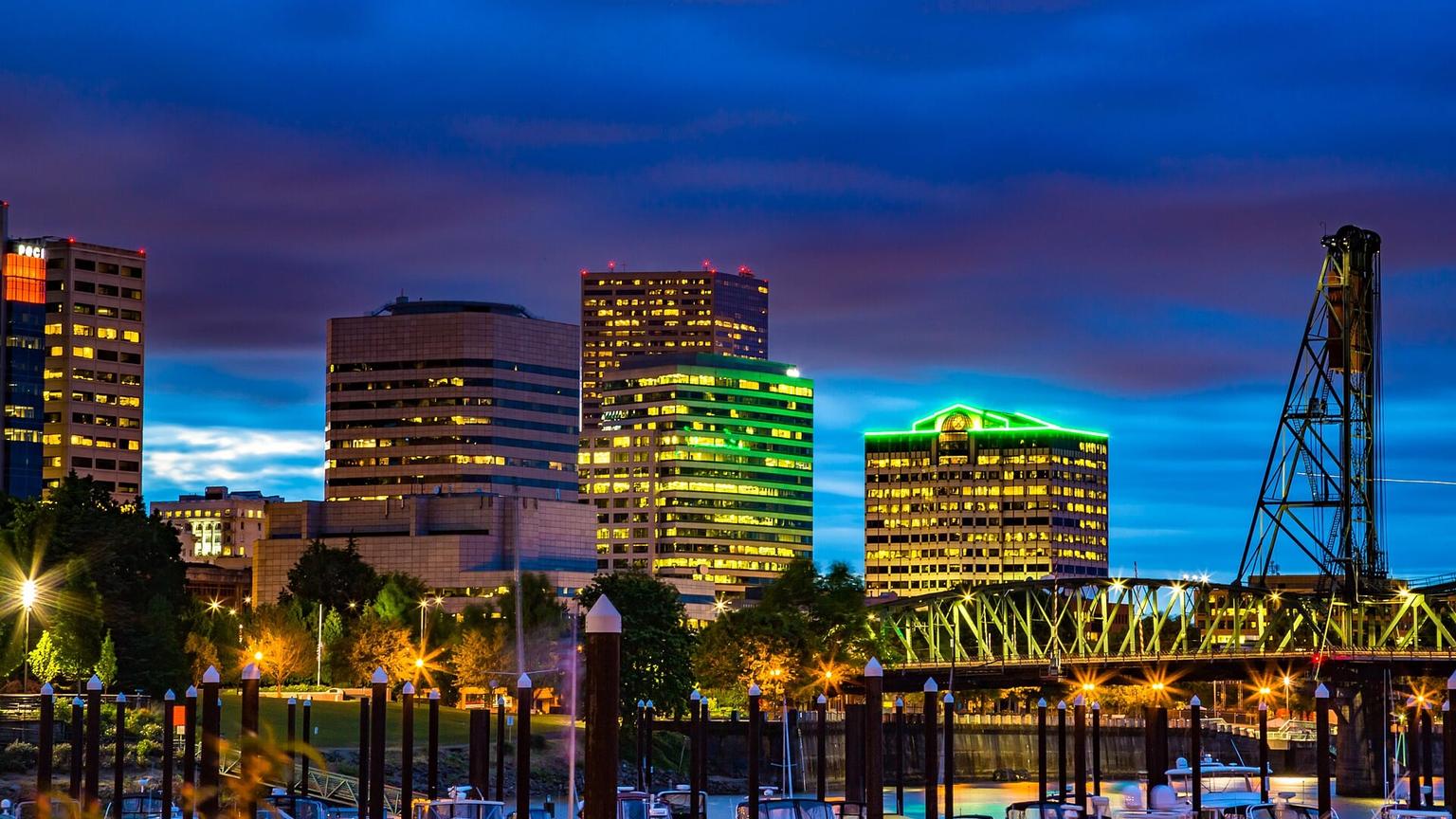 Portland skyline and waterfront beside the Willamette River at dusk