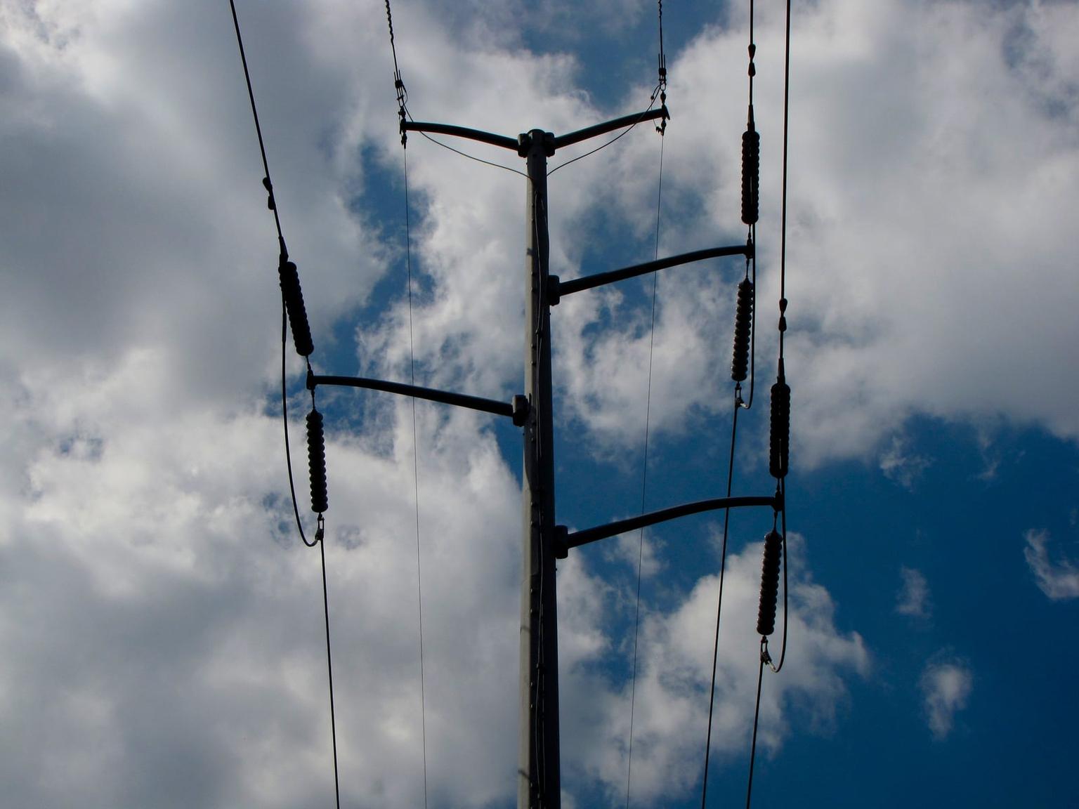 Overhead transmission lines and insulators against clouds in Richmond, Virginia