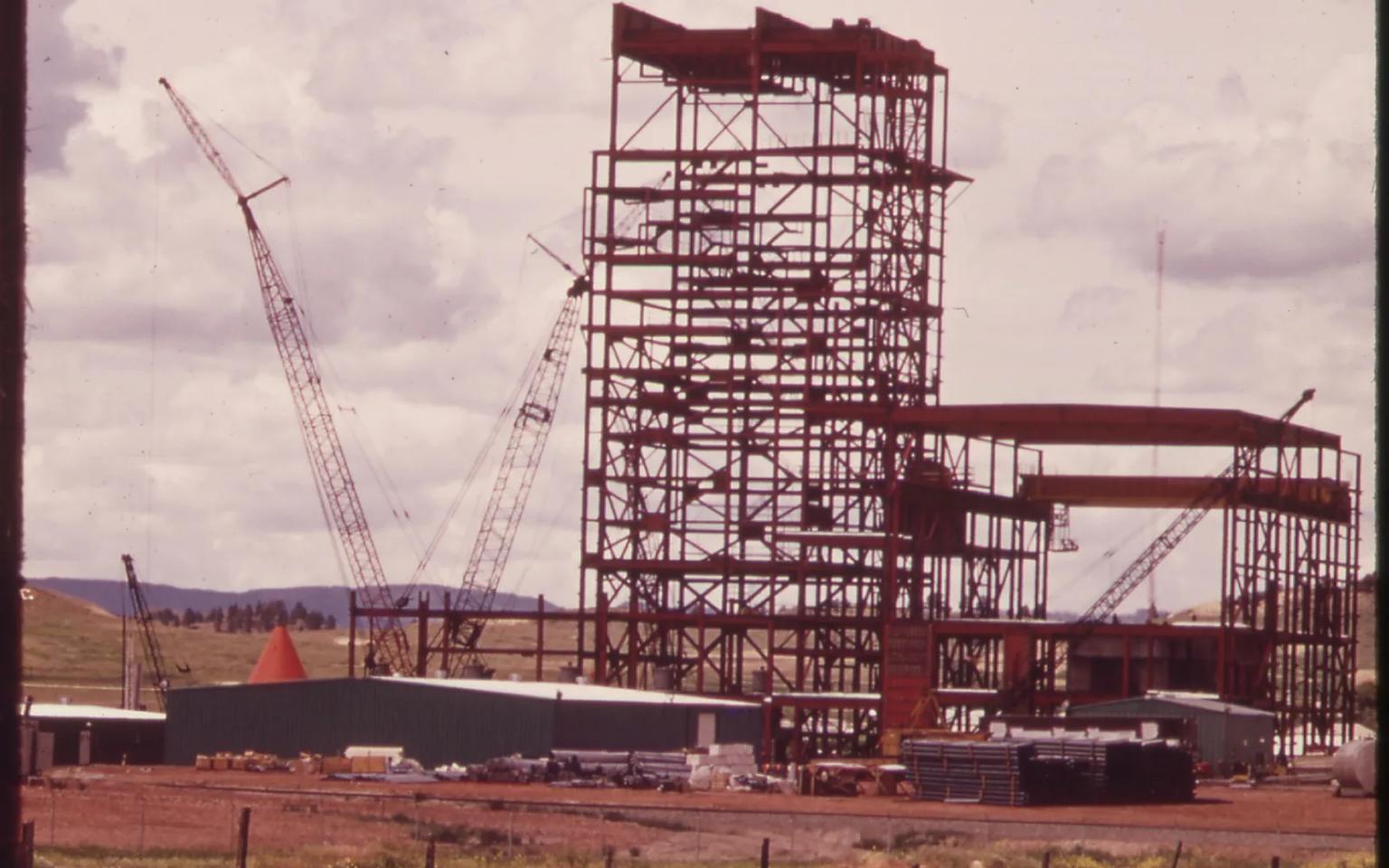 Steel framework of the first Colstrip generating unit under construction, with cranes, in June 1973