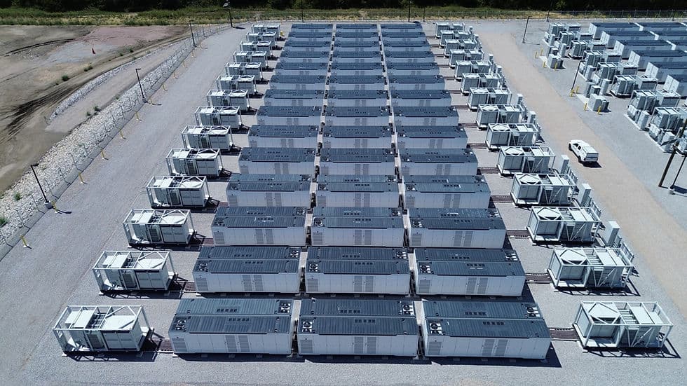 Aerial photograph of the Anole battery energy storage site near Seagoville, Texas, showing rows of gray battery enclosures and cooling equipment.